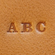 Initials pressed into the leather, raised